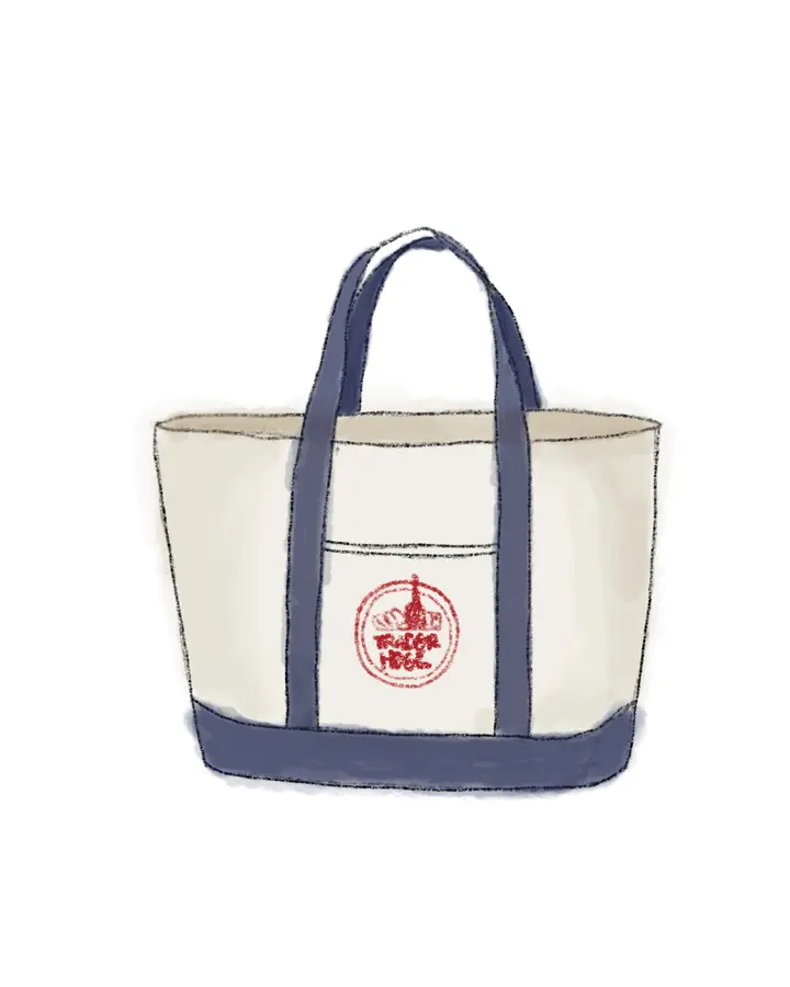 A canvas tote bag with navy handles